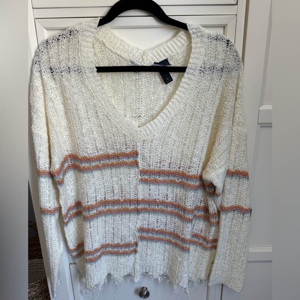 Light distressed sweater. Super comfortable. Only worn a few times. Like new.